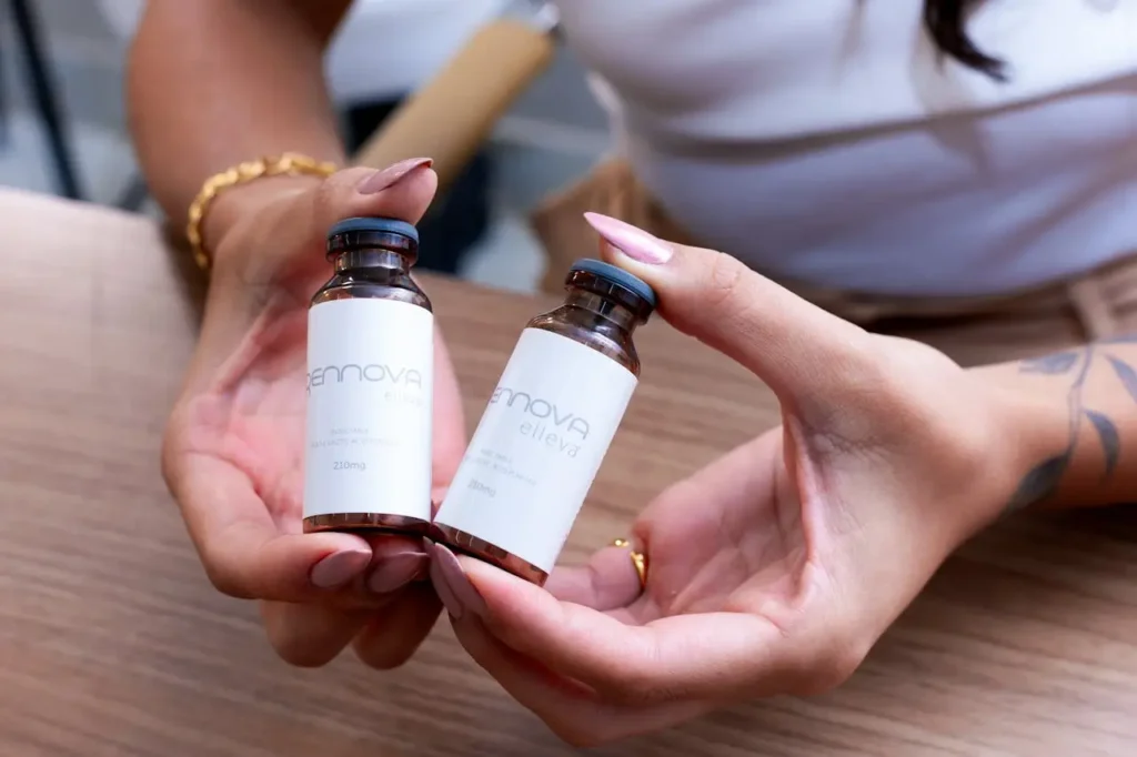 Close-up of a person holding two cosmetic treatment vials representing Dysport and Botox used for wrinkle reduction and facial rejuvenation.