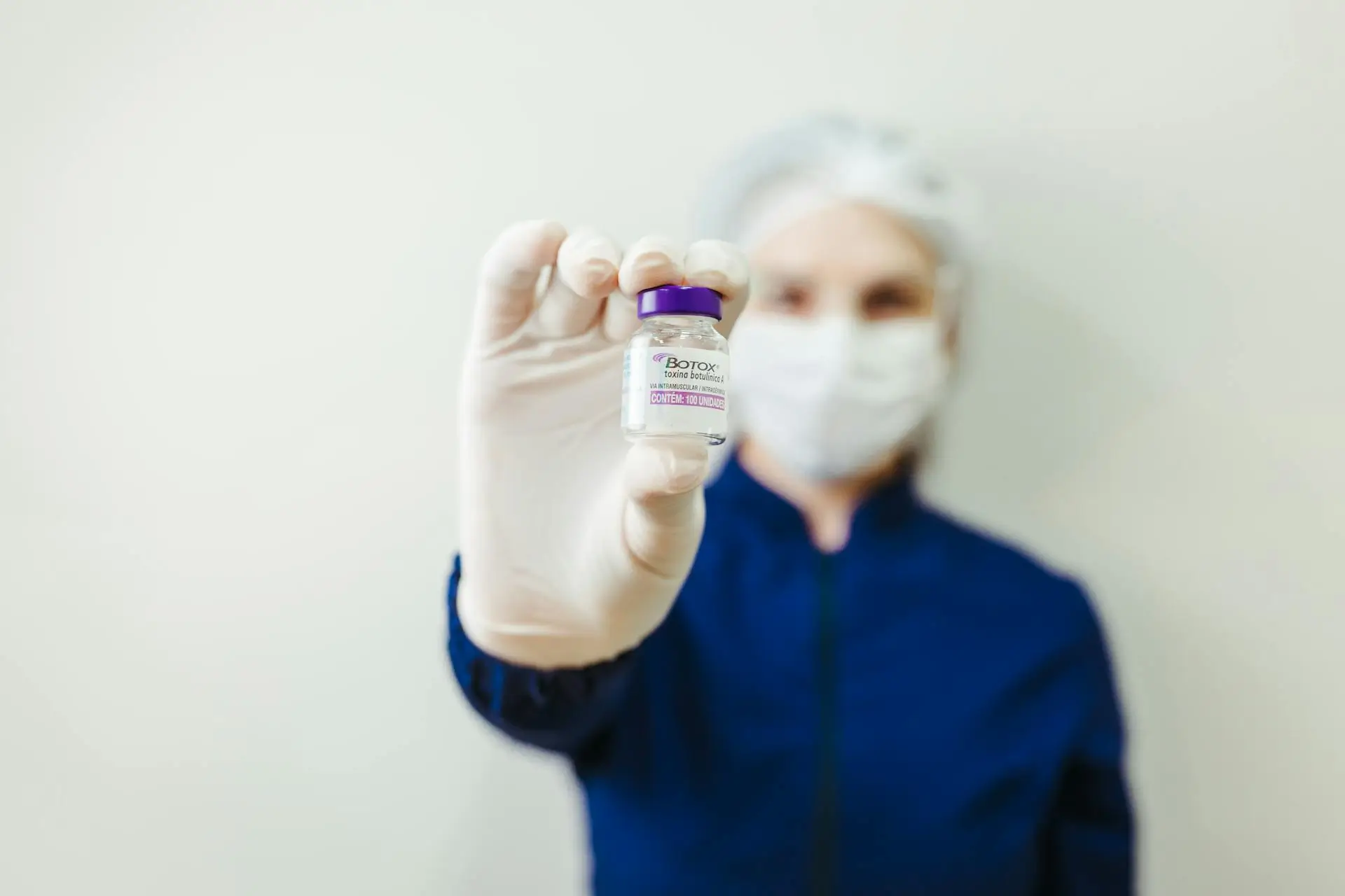 a girl has botox voil in her hand