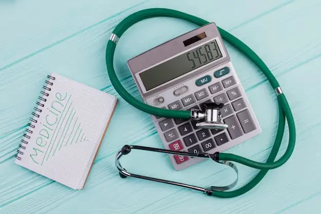 a stethoscope on a calculator collectively make a med calculator and also a notebook written medicine