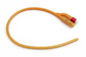 Hyper-realistic image of a Foley catheter made of amber latex with a red connector and smooth balloon tip, displayed in a natural curve on a white sterile background under soft clinical lighting.