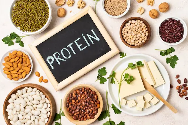 Flat lay of assorted seeds and grains forming a frame on a light background, representing protein-rich foods that support healthy hair.