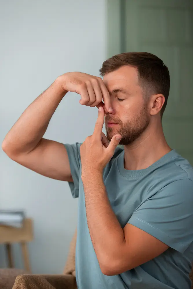 Man practicing alternate nostril breathing exercise to improve nasal airflow and reduce mouth breathing at night naturally