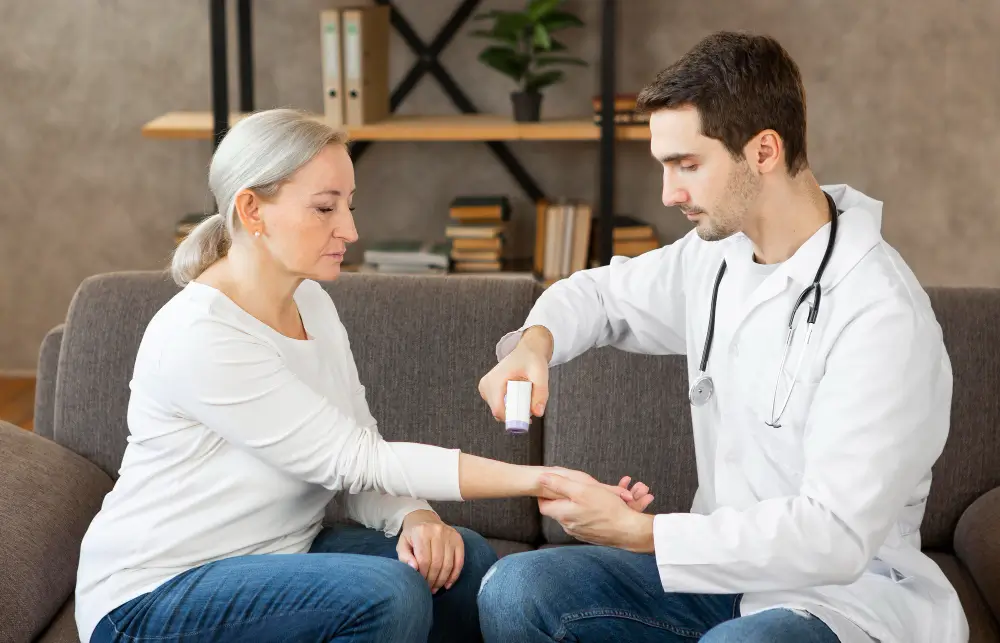 Doctor examining a woman’s wrist and applying wart removal treatment at home — illustrating safe methods to remove warts using medical-approved techniques under professional guidance.